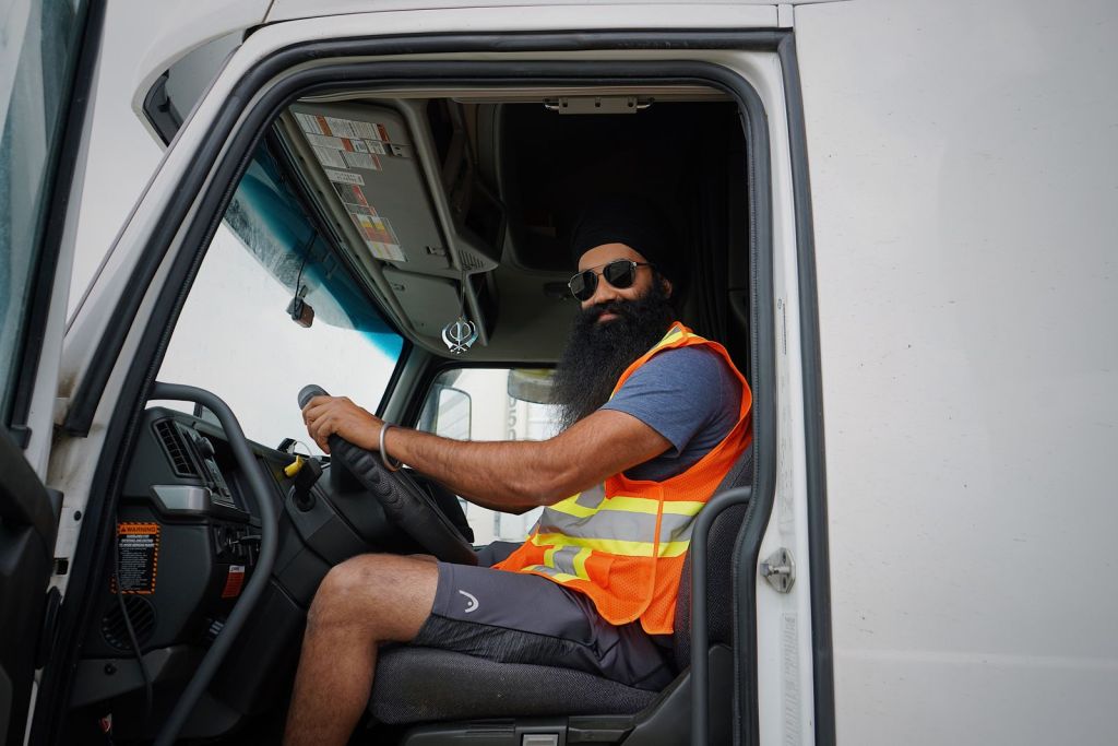 Owner operator at the wheel of a white commercial truck